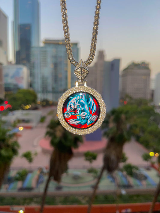 Custom iced Google Watch chain with a round gold pendant hanging in front of downtown Los Angeles